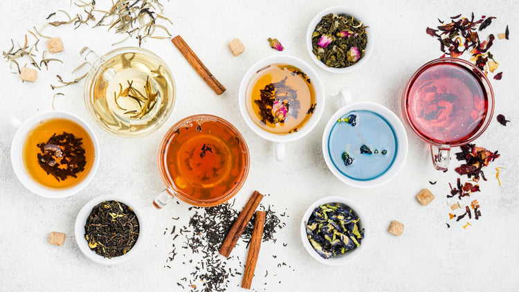 Herbal Teas - The Good Stuff featuring an assortment of colourful herbal teas in white cups with loose tea leaves and cinnamon sticks.